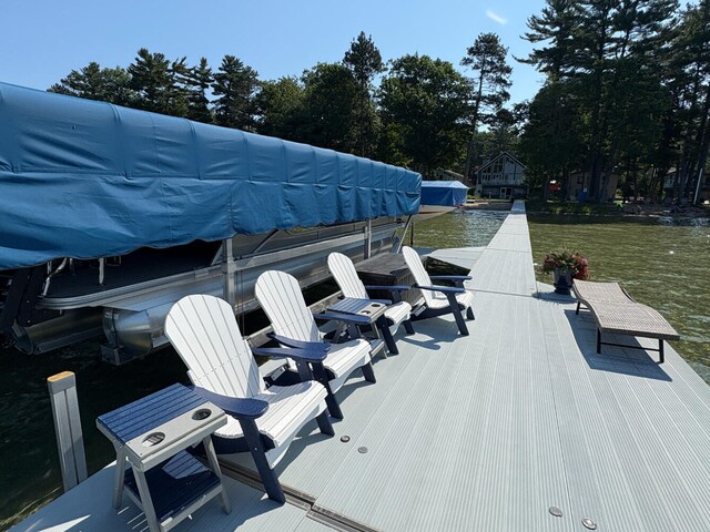 169 Pine Bluffs Rd, Roscommon, MI 48653 - dock area with view of wooded area and a lawn