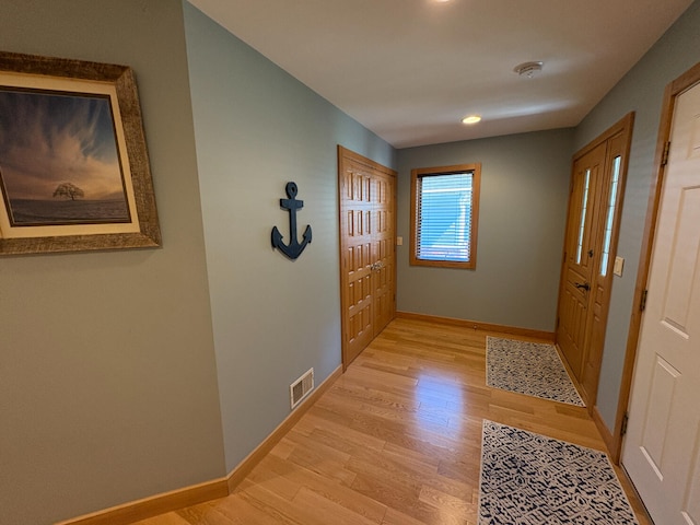 169 Pine Bluffs Rd, Roscommon, MI 48653 - hallway featuring light wood finished floors and baseboards