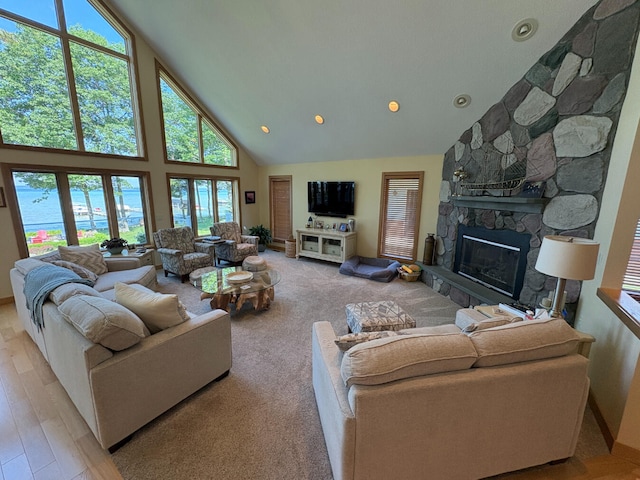 169 Pine Bluffs Rd, Roscommon, MI 48653 - living area featuring high vaulted ceiling, a stone fireplace, recessed lighting, and wood finished floors