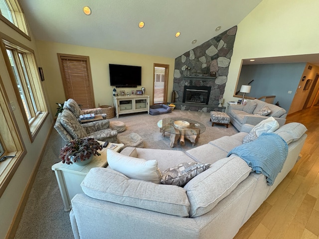 169 Pine Bluffs Rd, Roscommon, MI 48653 - living room with healthy amount of natural light, a stone fireplace, wood finished floors, recessed lighting, and high vaulted ceiling