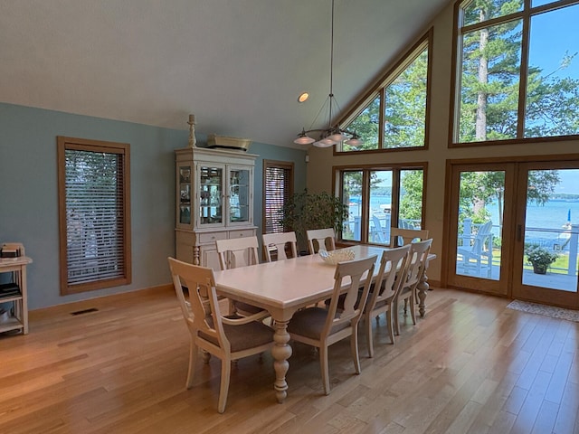 169 Pine Bluffs Rd, Roscommon, MI 48653 - dining space featuring high vaulted ceiling and light wood-type flooring