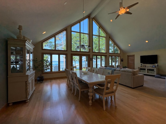 169 Pine Bluffs Rd, Roscommon, MI 48653 - dining room featuring high vaulted ceiling, healthy amount of natural light, beam ceiling, light wood finished floors, and a ceiling fan