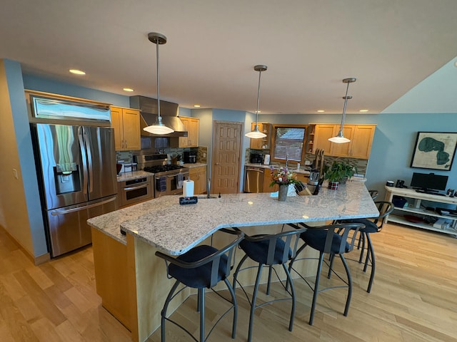 169 Pine Bluffs Rd, Roscommon, MI 48653 - kitchen featuring stainless steel appliances, exhaust hood, light wood-type flooring, a kitchen bar, and recessed lighting