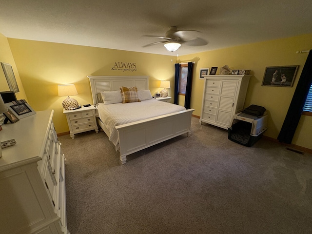 169 Pine Bluffs Rd, Roscommon, MI 48653 - bedroom with dark colored carpet and ceiling fan