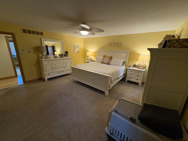 169 Pine Bluffs Rd, Roscommon, MI 48653 - bedroom with dark colored carpet and ceiling fan