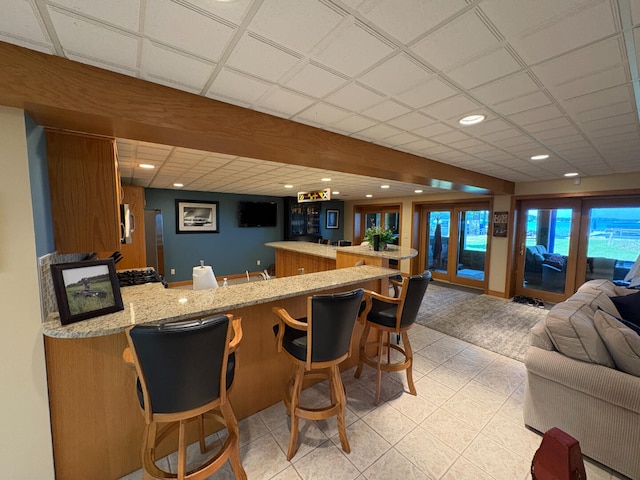 169 Pine Bluffs Rd, Roscommon, MI 48653 - indoor wet bar featuring light tile patterned floors, recessed lighting, and stainless steel microwave