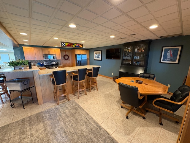 169 Pine Bluffs Rd, Roscommon, MI 48653 - indoor bar featuring stainless steel appliances, recessed lighting, light tile patterned floors, and backsplash