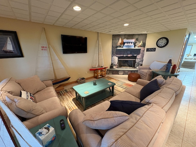 169 Pine Bluffs Rd, Roscommon, MI 48653 - tiled living area featuring a stone fireplace and recessed lighting
