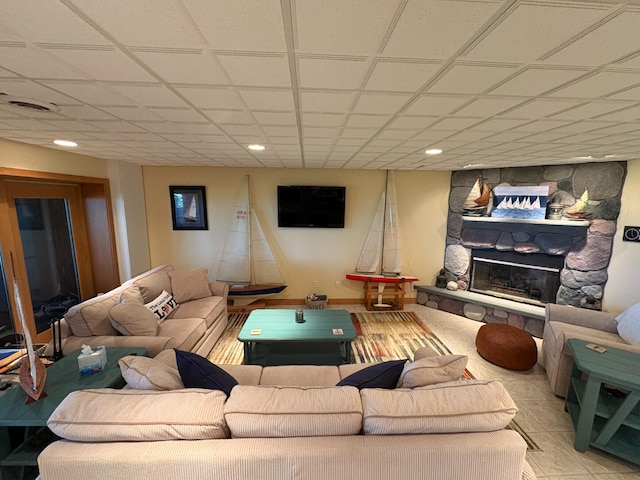 169 Pine Bluffs Rd, Roscommon, MI 48653 - living room featuring a stone fireplace, a drop ceiling, and recessed lighting