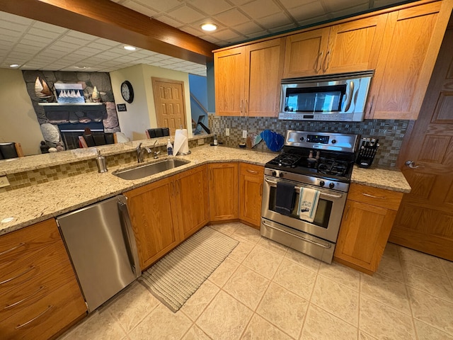 169 Pine Bluffs Rd, Roscommon, MI 48653 - kitchen featuring stainless steel appliances, decorative backsplash, brown cabinetry, and recessed lighting