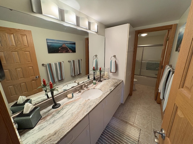 169 Pine Bluffs Rd, Roscommon, MI 48653 - full bathroom featuring vanity, combined bath / shower with glass door, and tile patterned flooring