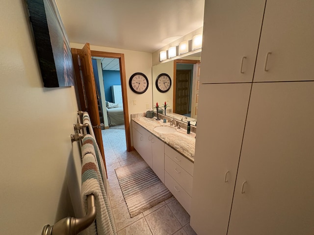 169 Pine Bluffs Rd, Roscommon, MI 48653 - ensuite bathroom with vanity and tile patterned floors