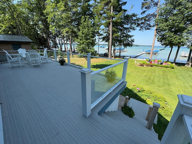 169 Pine Bluffs Rd, Roscommon, MI 48653 - wooden deck featuring a water view, a yard, and outdoor dining area