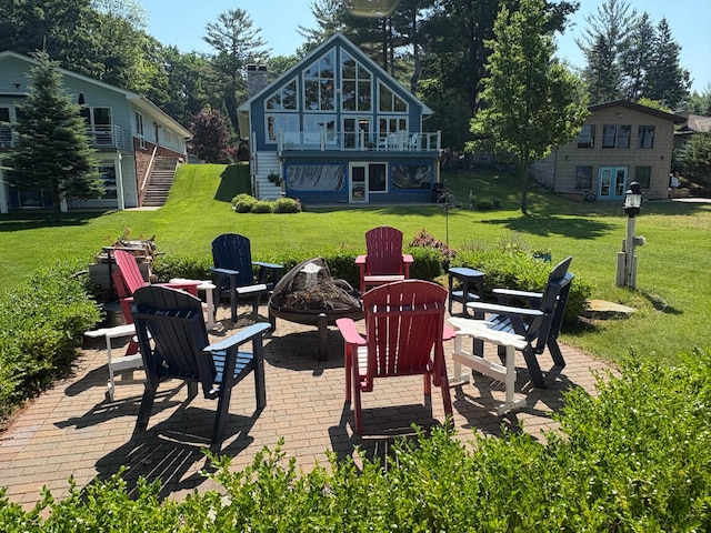 169 Pine Bluffs Rd, Roscommon, MI 48653 - patio / terrace featuring an outdoor fire pit, french doors, a patio, and a lawn