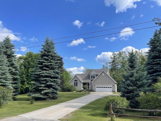 12395 Atkinson Rd, Lachine, MI 49753 - view of front facade featuring a front lawn, driveway, and an attached garage