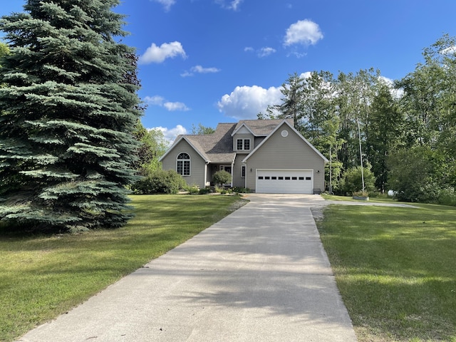 12395 Atkinson Rd, Lachine, MI 49753 - view of front of house featuring asphalt driveway, a garage, and a front yard