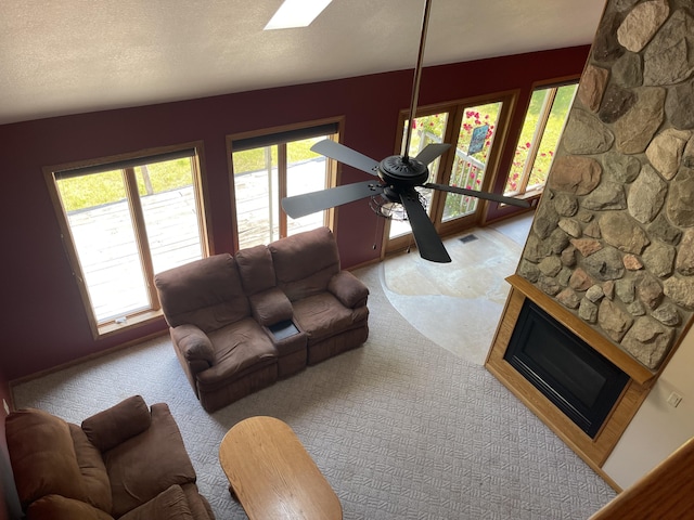 12395 Atkinson Rd, Lachine, MI 49753 - living area with plenty of natural light, carpet floors, and a fireplace