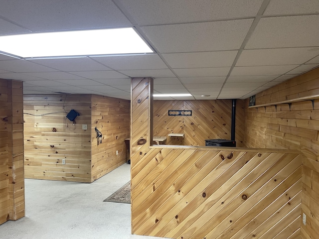 12395 Atkinson Rd, Lachine, MI 49753 - hallway featuring wooden walls, a paneled ceiling, and carpet floors