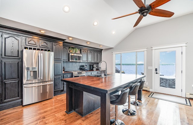 319 Old Trl, Houghton Lake, MI 48629 - kitchen featuring stainless steel appliances, light wood finished floors, wooden counters, recessed lighting, and a water view