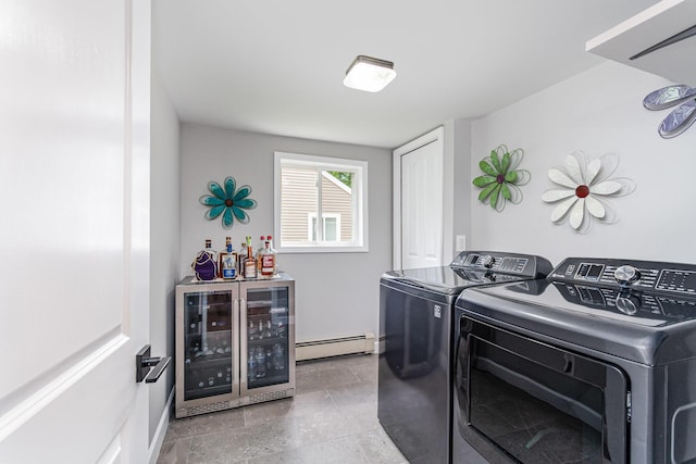 319 Old Trl, Houghton Lake, MI 48629 - laundry area featuring a baseboard radiator, washer and dryer, a bar, and beverage cooler