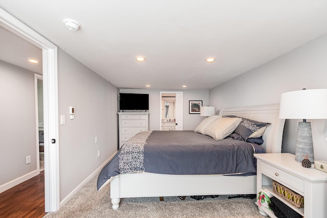 319 Old Trl, Houghton Lake, MI 48629 - bedroom featuring recessed lighting, wood finished floors, and connected bathroom