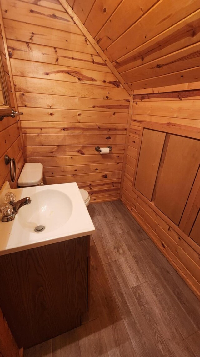 1025 Lake Side Trl, Barton City, MI 48705 - bathroom with vaulted ceiling, vanity, wooden walls, wood finished floors, and wood ceiling