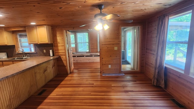 1025 Lake Side Trl, Barton City, MI 48705 - kitchen featuring light wood finished floors, a ceiling fan, plenty of natural light, wooden walls, and recessed lighting