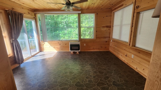 1025 Lake Side Trl, Barton City, MI 48705 - spare room with heating unit, stone floors, wooden ceiling, wood walls, and a ceiling fan