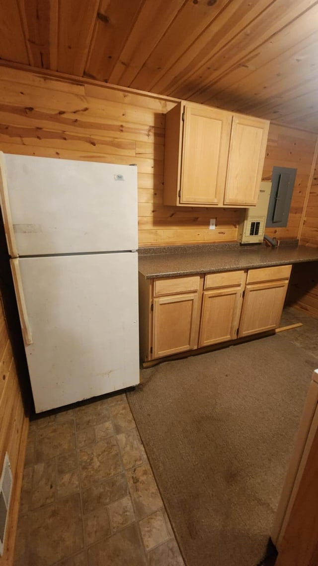 1025 Lake Side Trl, Barton City, MI 48705 - kitchen with freestanding refrigerator, wood walls, dark countertops, wood ceiling, and electric panel