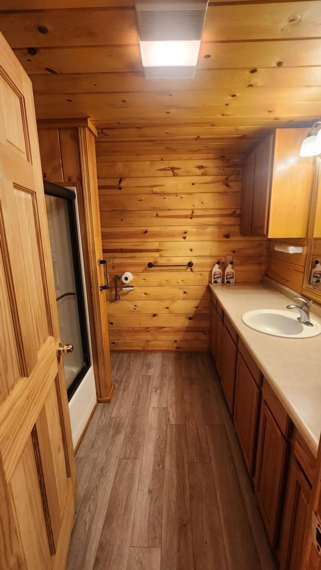1025 Lake Side Trl, Barton City, MI 48705 - full bathroom featuring vanity, hardwood / wood-style flooring, wooden ceiling, and combined bath / shower with glass door