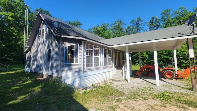 1025 Lake Side Trl, Barton City, MI 48705 - view of property exterior with a carport, entry steps, and a lawn