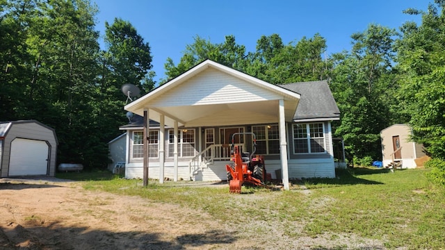 1025 Lake Side Trl, Barton City, MI 48705 - view of front of home featuring an outbuilding, a porch, a front lawn, and a detached garage