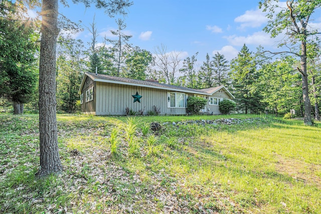 5699 N Red Oak Rd, Lewiston, MI 49756 - view of home's exterior with board and batten siding