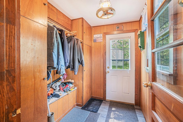5699 N Red Oak Rd, Lewiston, MI 49756 - mudroom featuring wooden walls, tile patterned floors, and a chandelier