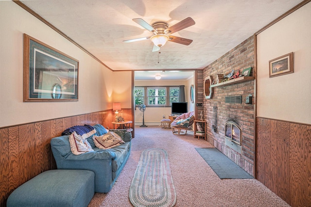 5699 N Red Oak Rd, Lewiston, MI 49756 - living room featuring wood walls, carpet, a wainscoted wall, ceiling fan, and a brick fireplace
