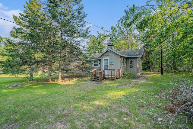 5699 N Red Oak Rd, Lewiston, MI 49756 - back of property with a yard and a chimney