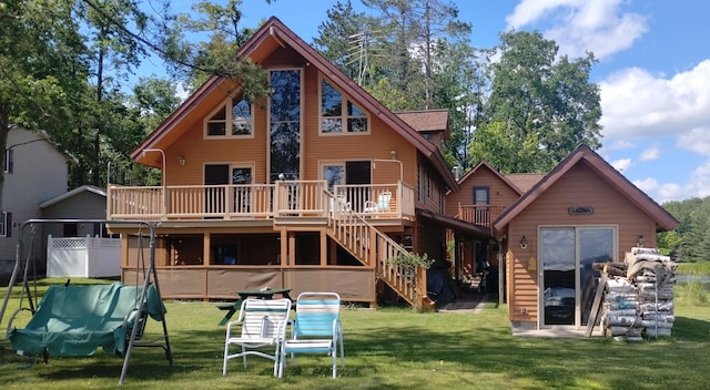 19241 Pine Tree Ct, Hillman, MI 49746 - back of house featuring a deck, stairway, and a lawn