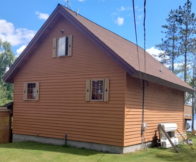 19241 Pine Tree Ct, Hillman, MI 49746 - view of side of property with a shingled roof and a yard