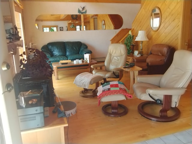 19241 Pine Tree Ct, Hillman, MI 49746 - living room featuring wood finished floors, wooden walls, and a baseboard heating unit