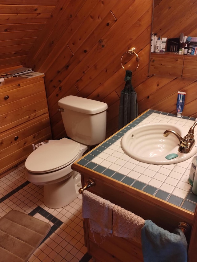 19241 Pine Tree Ct, Hillman, MI 49746 - bathroom featuring vanity, tile patterned floors, and wooden walls