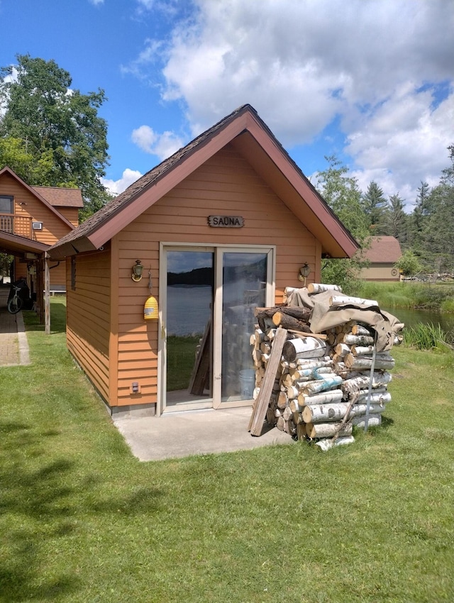 19241 Pine Tree Ct, Hillman, MI 49746 - rear view of house featuring a lawn and an outdoor structure