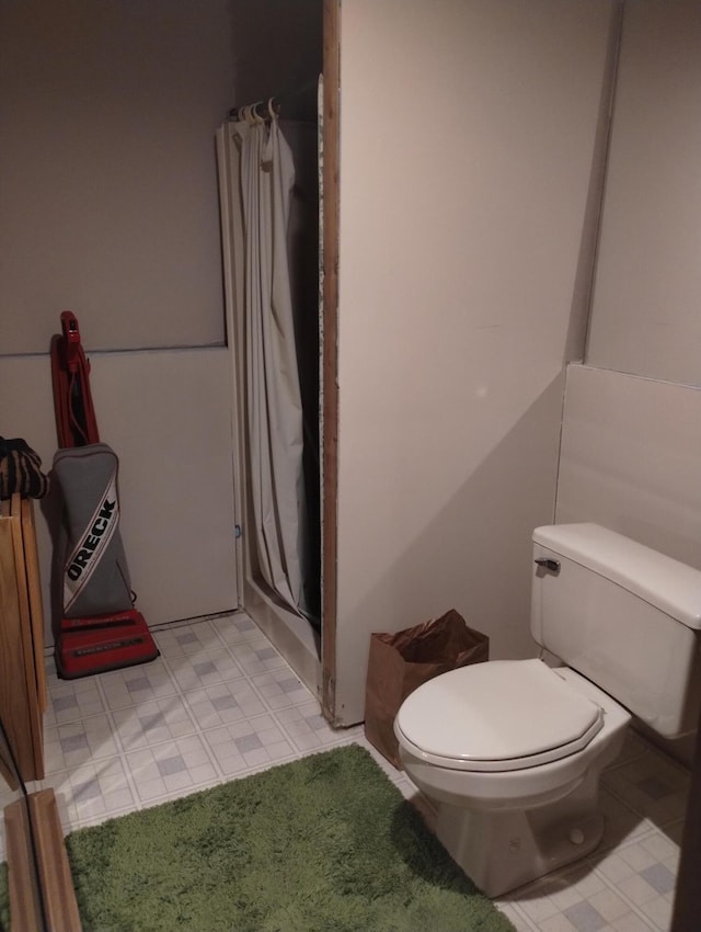 19241 Pine Tree Ct, Hillman, MI 49746 - bathroom featuring a shower with curtain and toilet