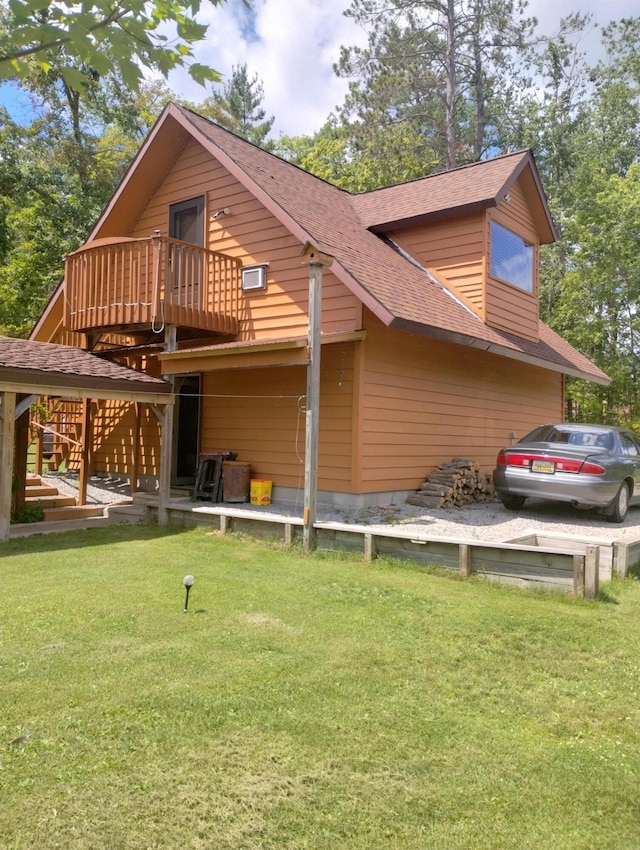 19241 Pine Tree Ct, Hillman, MI 49746 - back of house with a yard, a shingled roof, and a wooden deck