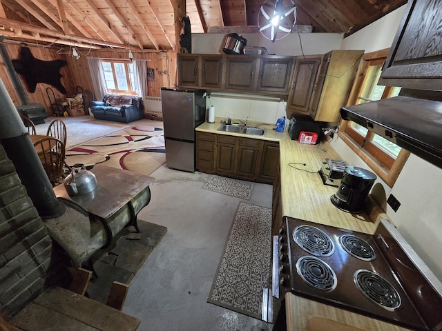1987 N Galbraith Rd, Mio, MI 48647 - kitchen featuring wood ceiling, cooktop, light countertops, freestanding refrigerator, and concrete floors