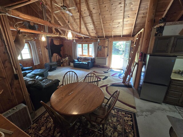 1987 N Galbraith Rd, Mio, MI 48647 - dining space featuring plenty of natural light, wood ceiling, wooden walls, light carpet, and a chandelier