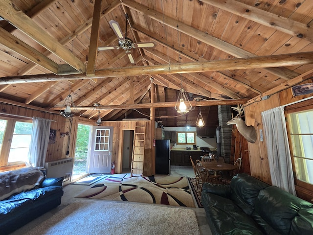 1987 N Galbraith Rd, Mio, MI 48647 - living area with wood walls, a wood ceiling with exposed beams, plenty of natural light, high vaulted ceiling, and a ceiling fan