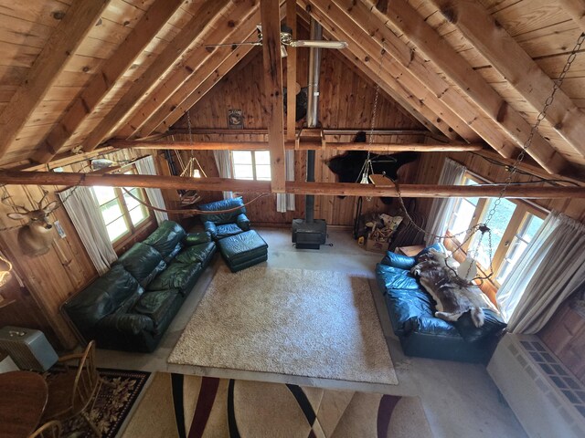 1987 N Galbraith Rd, Mio, MI 48647 - living area featuring wood ceiling, wood walls, plenty of natural light, and a wood stove