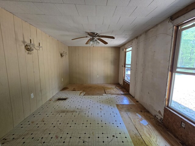 8361 Brookfield Dr, Elmira, MI 49730 - spare room with a ceiling fan and wooden walls