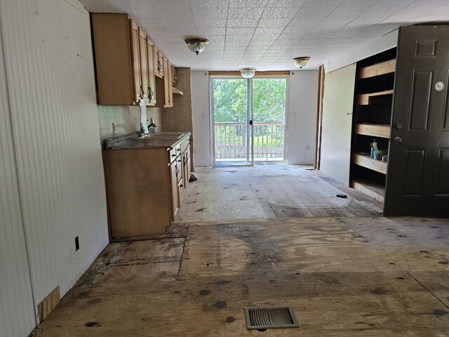 8361 Brookfield Dr, Elmira, MI 49730 - kitchen with dark countertops and brown cabinets