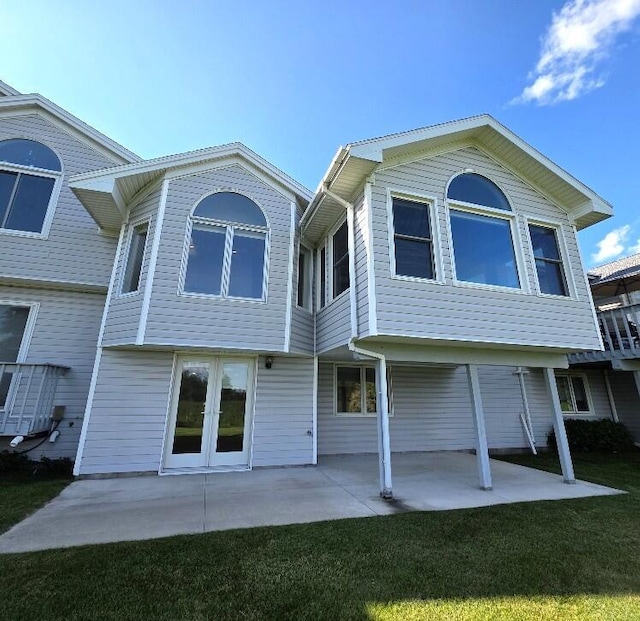176 Long Rapids Rd, Alpena, MI 49707 - rear view of property featuring a patio area and a lawn
